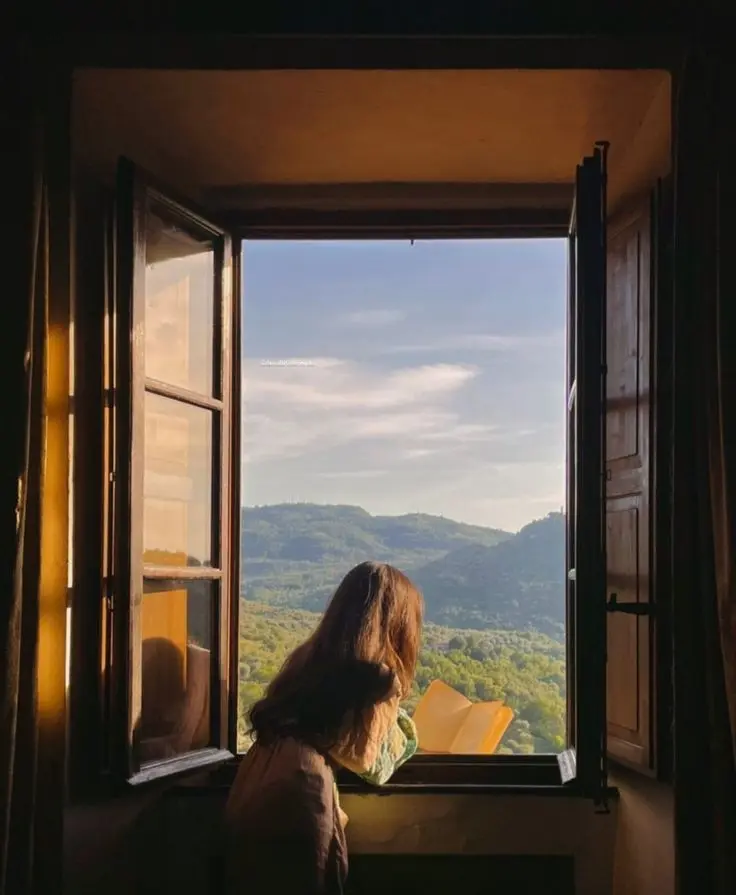 Tips for a Balanced Lifestyle": Woman reflecting on a balanced lifestyle by window